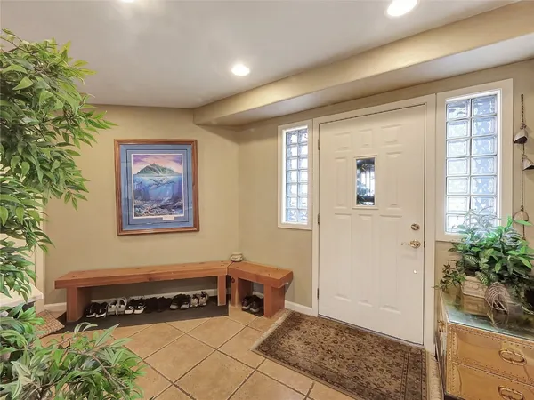 a view of a hallway with closet and wooden floor