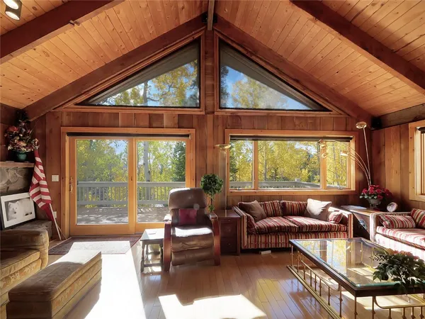 a living room with patio furniture and a large window