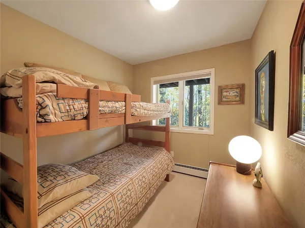 a spacious bedroom with a bed and window