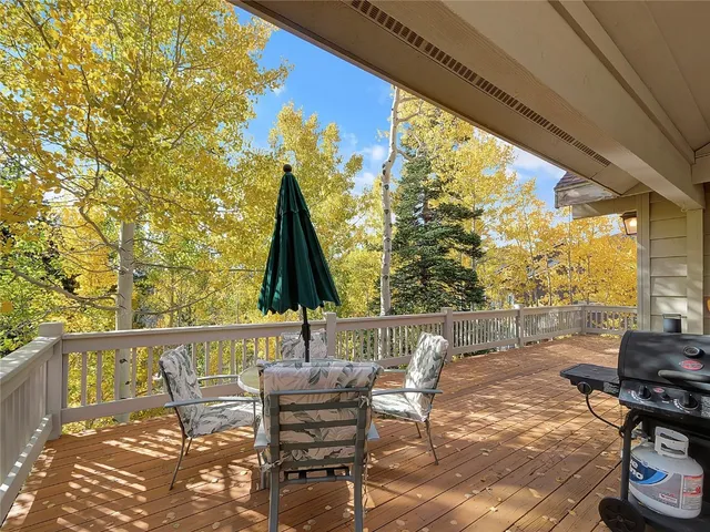 a view of deck with furniture and barbeque grill with wooden fence
