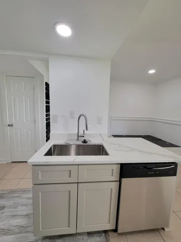 a kitchen with a sink and a refrigerator