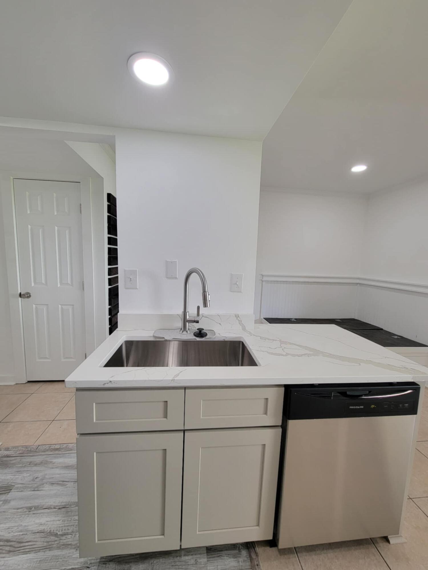 145 4th Avenue, Unit B3 Shalimar, FL 32579 - Photo 11 of 46 a kitchen with a sink and a refrigerator