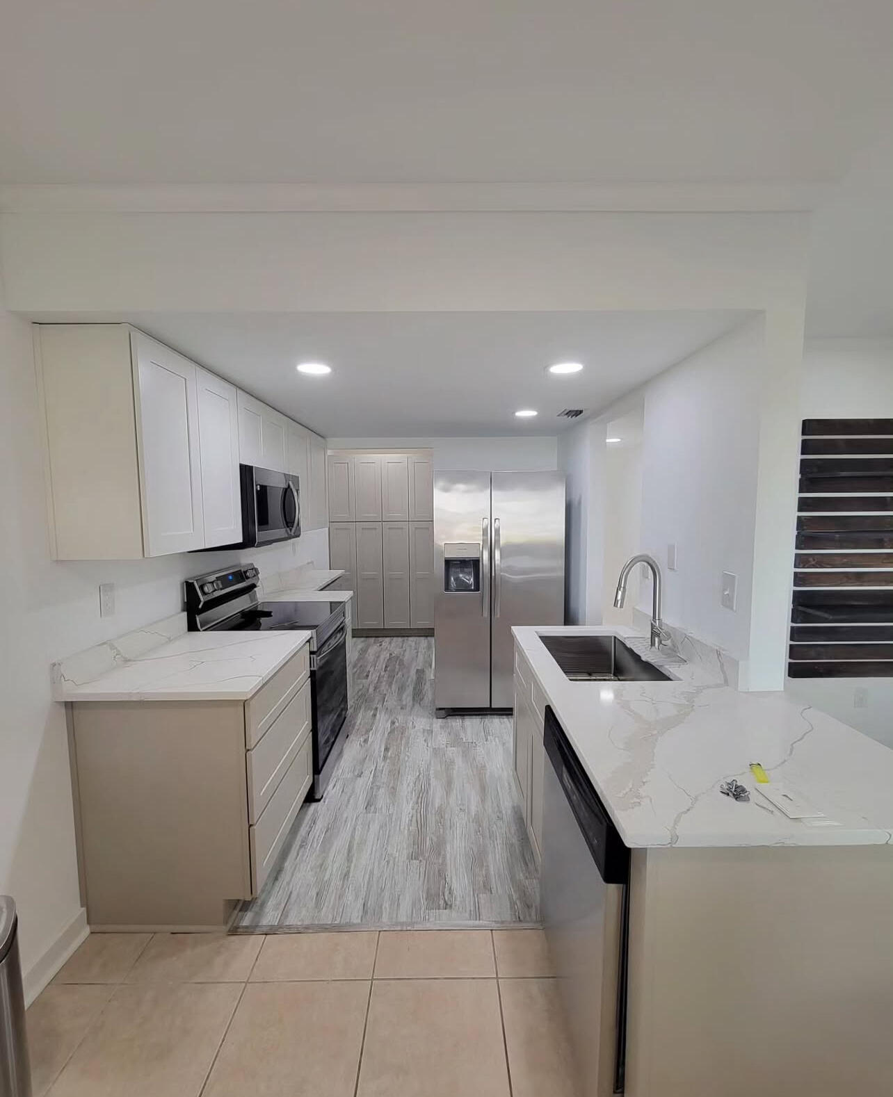 145 4th Avenue, Unit B3 Shalimar, FL 32579 - Photo 14 of 46 a kitchen with a sink a counter top space stainless steel appliances and cabinets