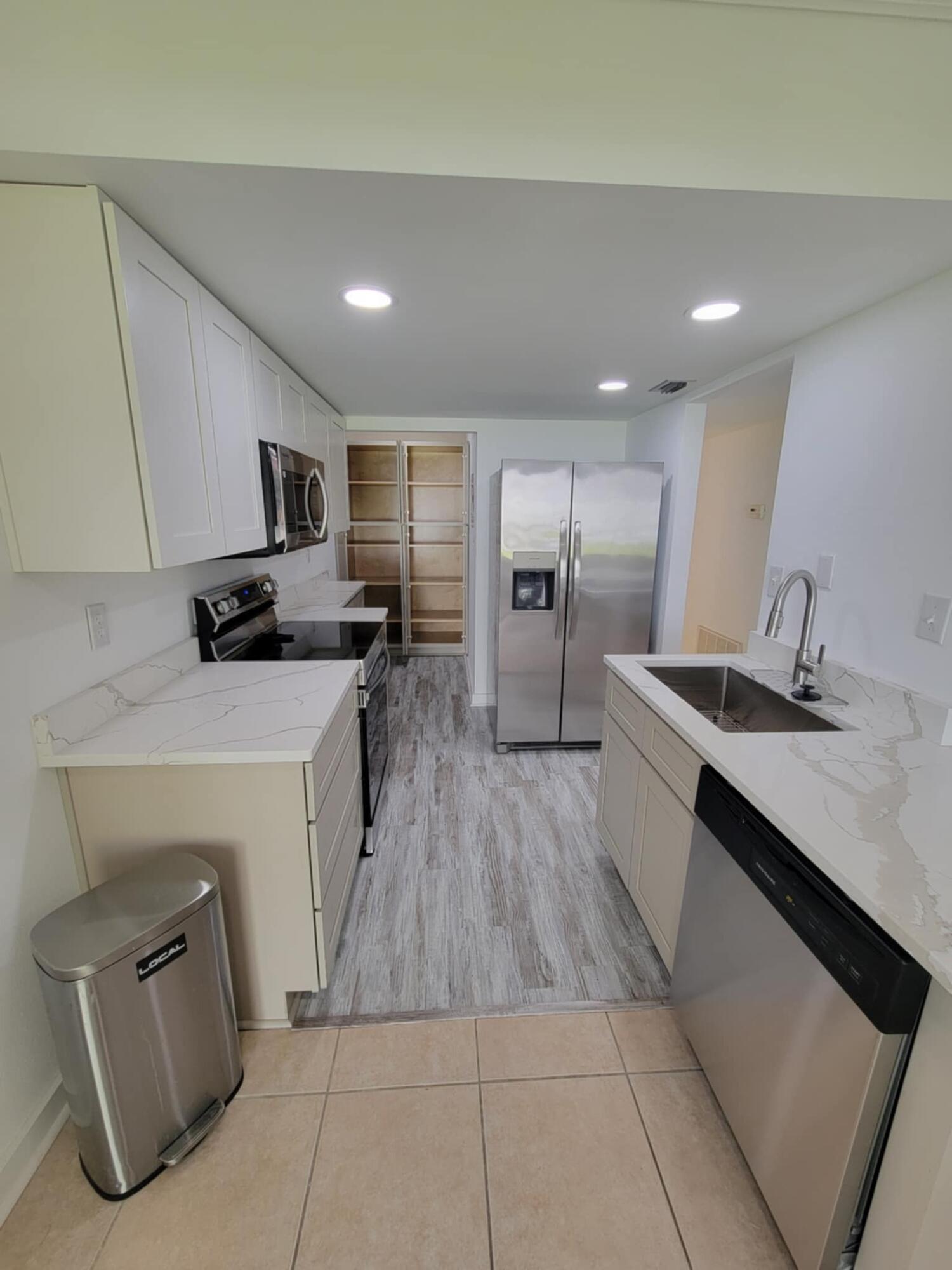 145 4th Avenue, Unit B3 Shalimar, FL 32579 - Photo 16 of 46 a kitchen with granite countertop a sink a counter top space stainless steel appliances and cabinets