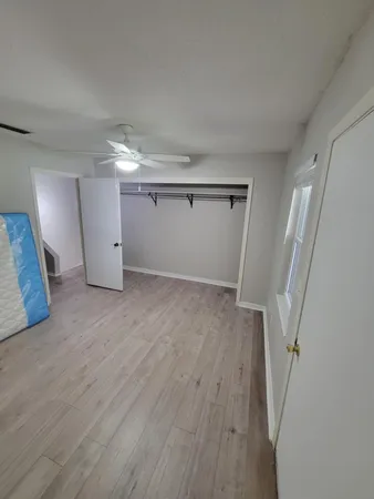 a view of a room with wooden floor