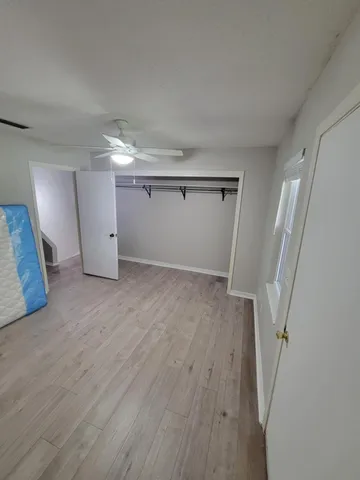 a view of a room with wooden floor