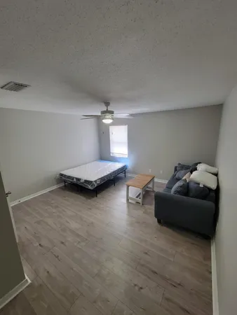 a living room with furniture and a rug