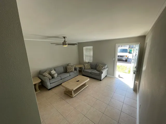 a view of a house with a big yard and a large tree