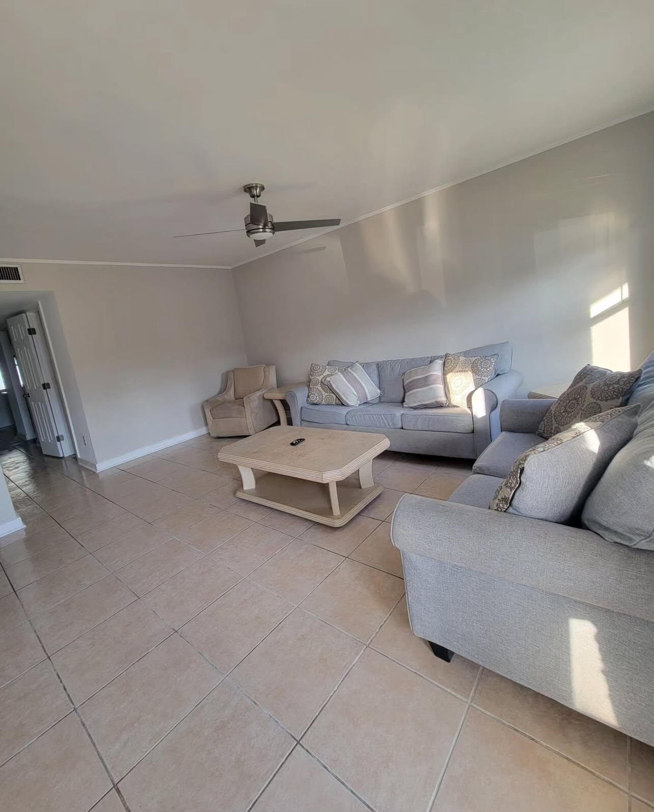 145 4th Avenue, Unit B3 Shalimar, FL 32579 - Photo 5 of 46 a living room with furniture and a lamp