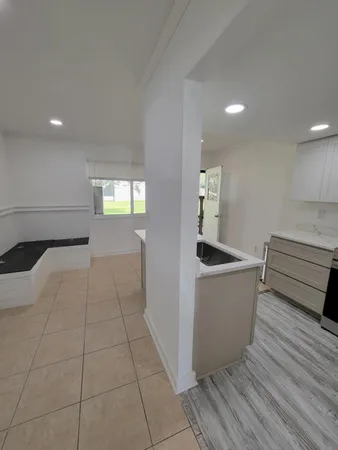 a kitchen with granite countertop a sink a stove and cabinets