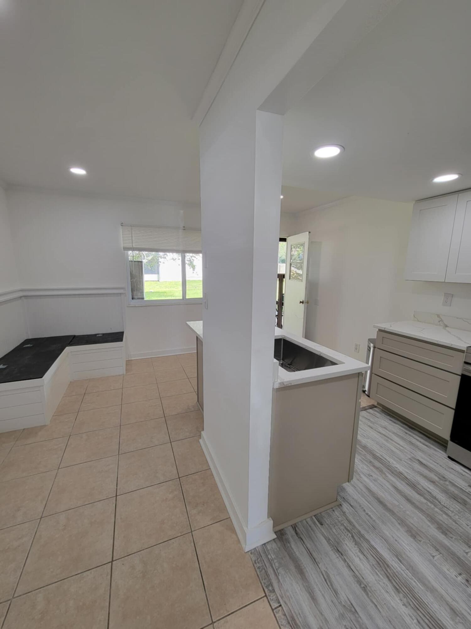 145 4th Avenue, Unit B3 Shalimar, FL 32579 - Photo 8 of 46 a kitchen with granite countertop a sink a stove and cabinets