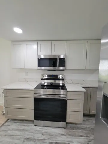 a stove top oven sitting inside of a kitchen