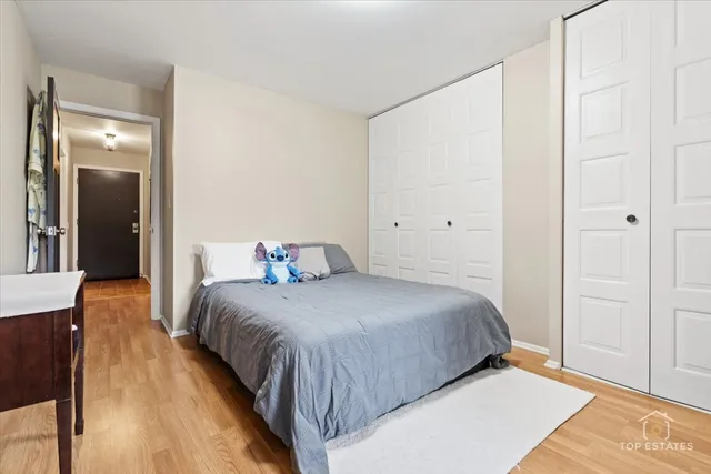 a bedroom with a bed and wooden floor