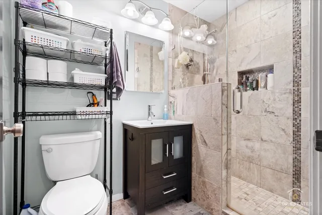 a bathroom with a toilet a sink and a mirror