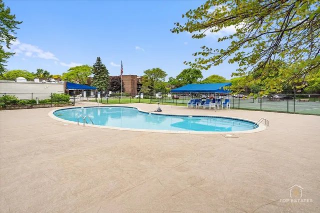 a view of a swimming pool with an outdoor space and seating area