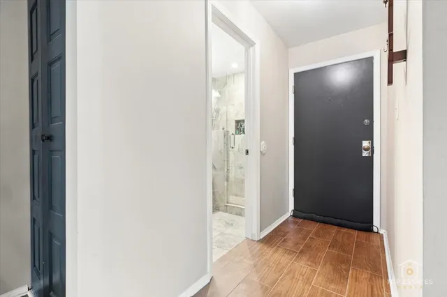 a view of a room with wooden floor