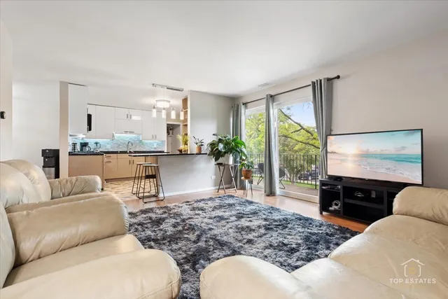 a living room with furniture large window and flat screen tv