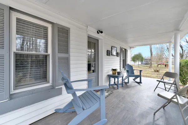 a living room with furniture a wooden floor and a sink