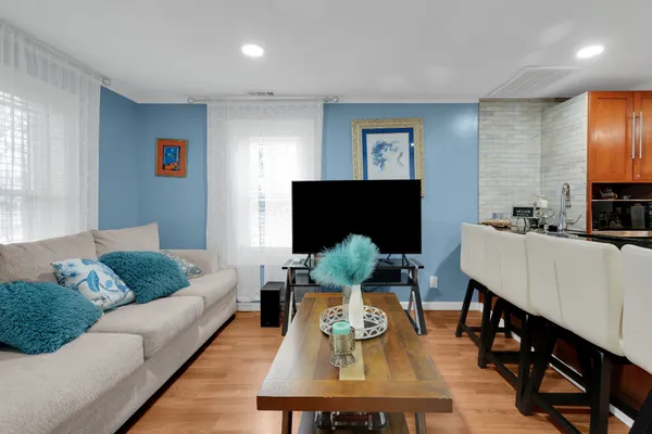 a kitchen with stainless steel appliances granite countertop a sink a stove and a refrigerator