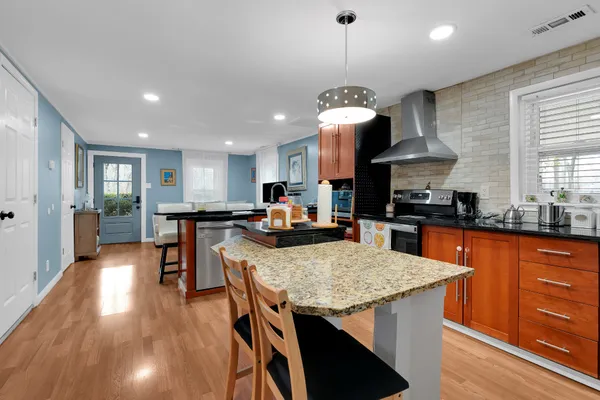 a bathroom with a granite countertop sink a mirror and a shower