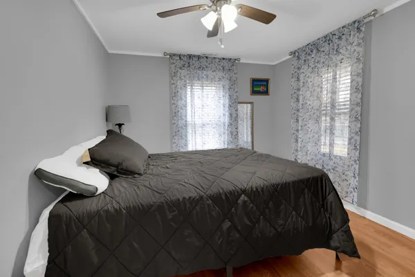 a bedroom with a bed and a painting on the wall