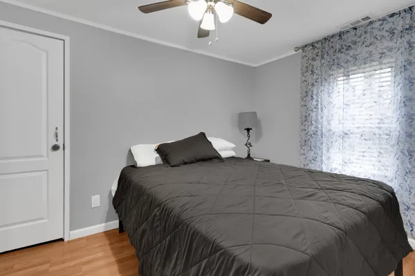 a bedroom with a bed and a chandelier