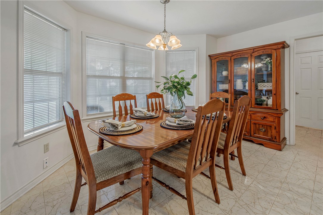 1110 County Road 439 Dime Box, TX 77853 - Photo 15 of 50 a dining room with furniture a potted plant and a chandelier