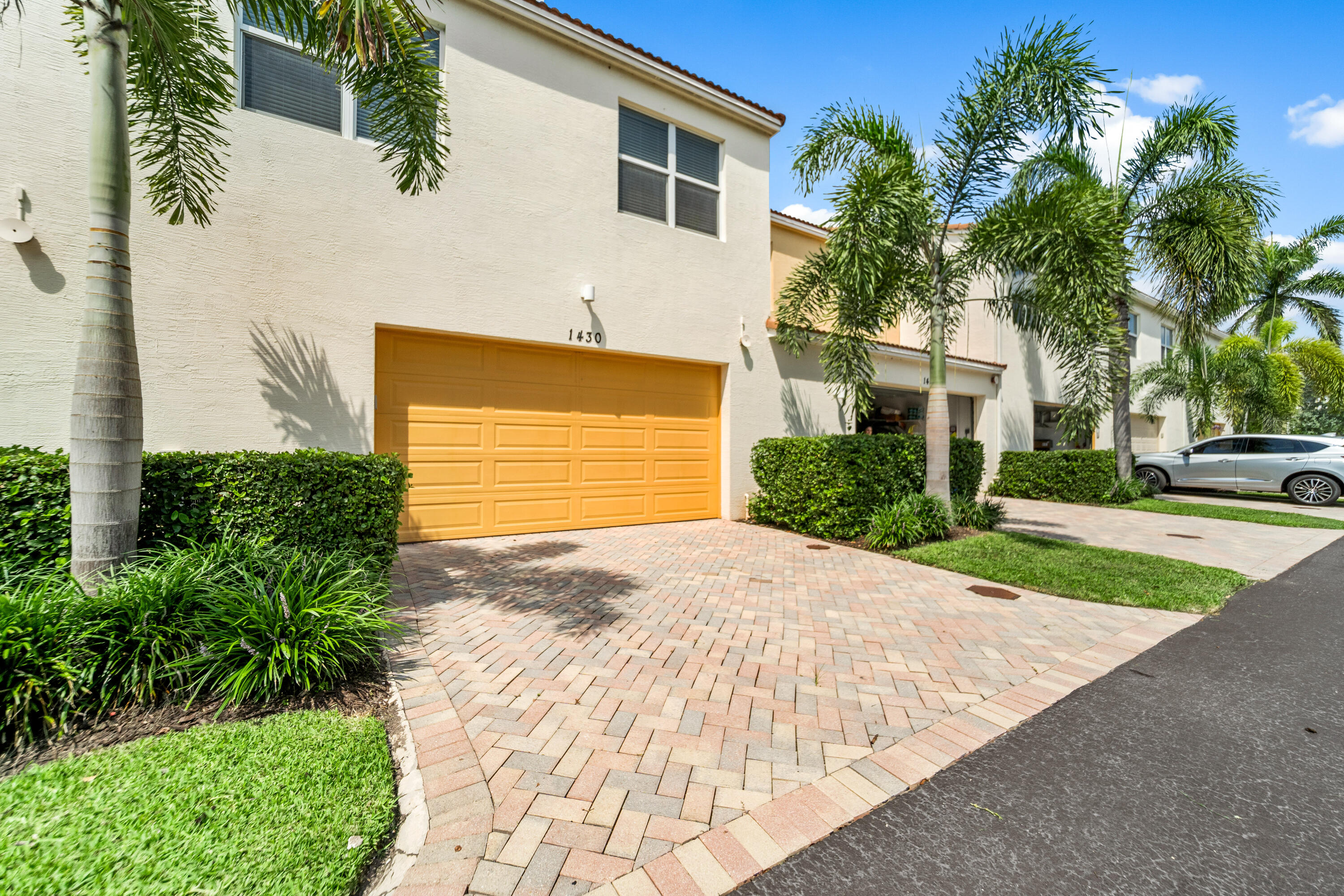 1430 Northwest 48th Lane Boca Raton, FL 33431 - Photo 33 of 54 a front view of a house with a yard and garage