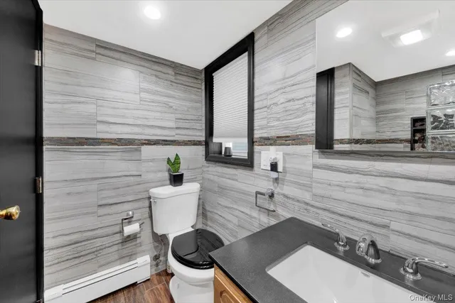 a bed room with a bed and a flat tv screen