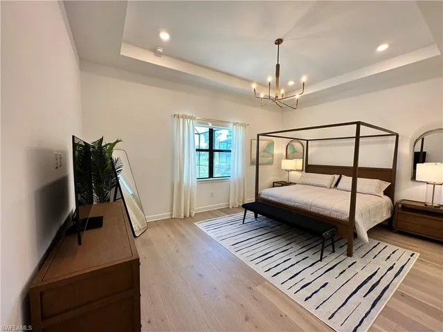a bedroom with furniture window and wooden floor