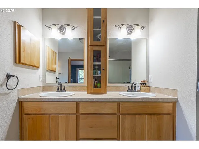 a bathroom with a double vanity sink and mirror
