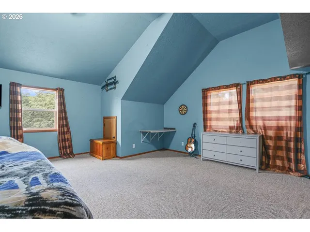 a bedroom with furniture and windows