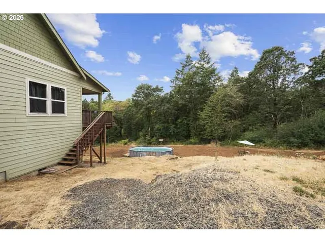 a view of a backyard of the house