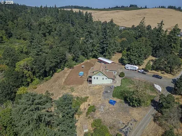 an aerial view of a house with a lake view