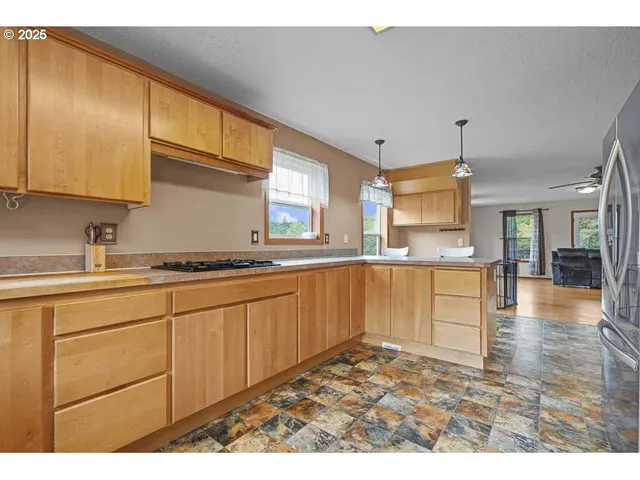 a kitchen with granite countertop a sink cabinets and wooden floor
