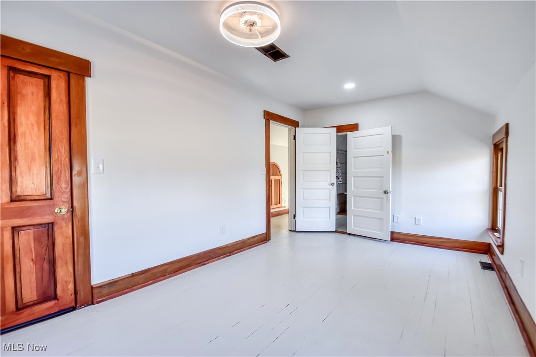6416 Chapel Road Madison, OH 44057 - Photo 28 of 35 Spare room with visible vents, recessed lighting, lofted ceiling, and baseboards