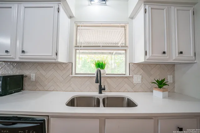 a kitchen with a sink and cabinets