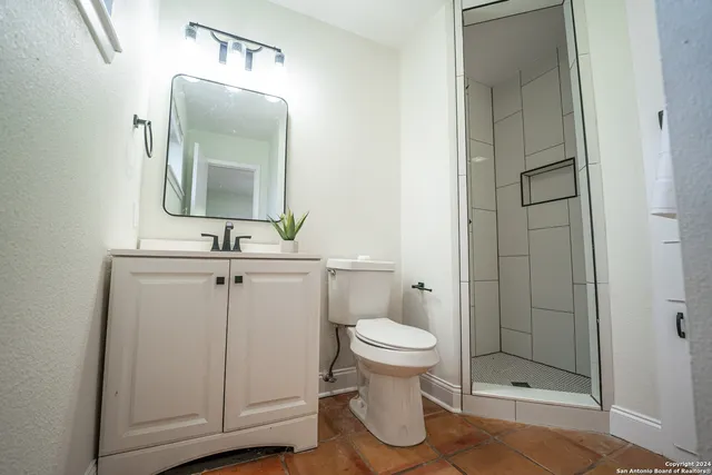 a bathroom with a toilet and a shower