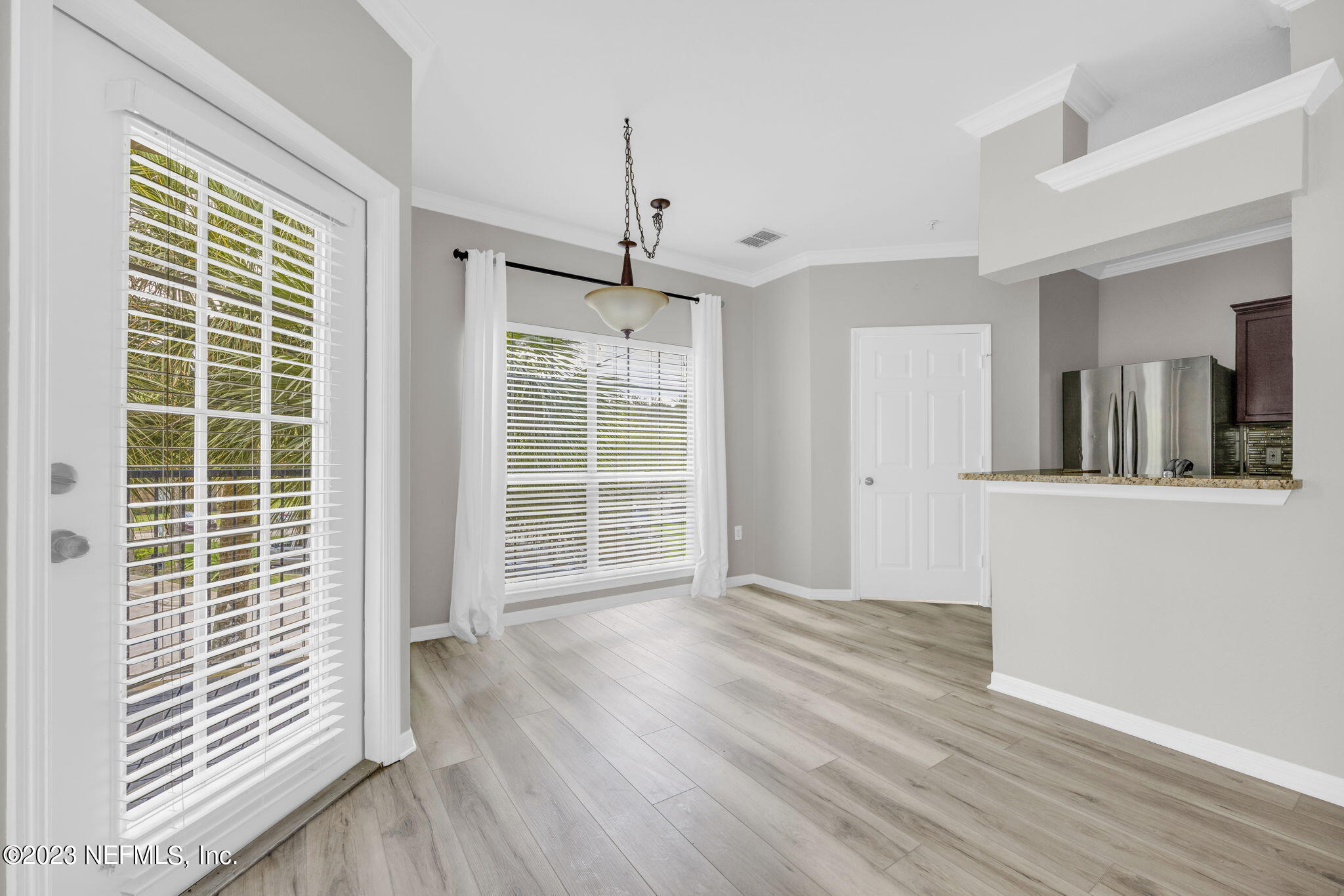 10961 Burnt Mill Road, Unit 427 Jacksonville, FL 32256 - Photo 12 of 50 a view of an empty room with wooden floor and a window