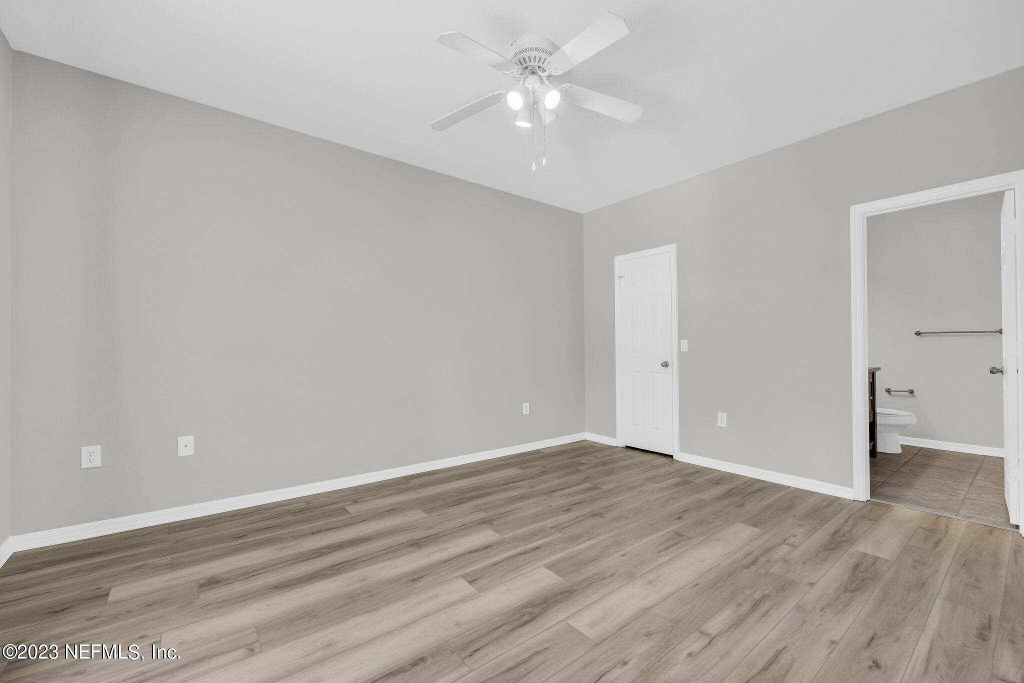 10961 Burnt Mill Road, Unit 427 Jacksonville, FL 32256 - Photo 18 of 50 wooden floor in an empty room