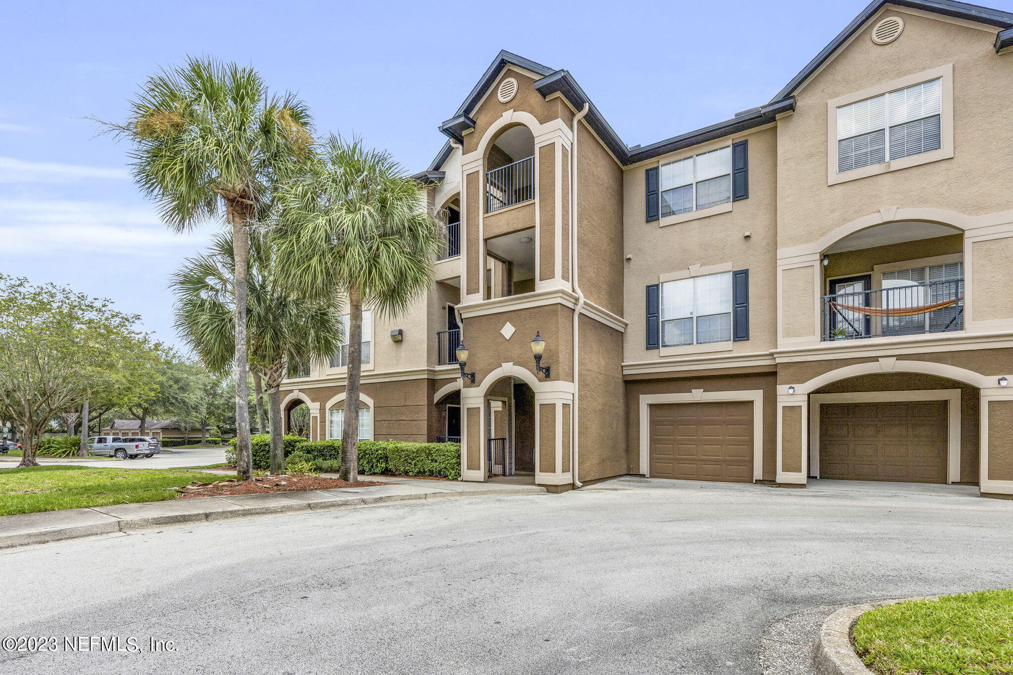 10961 Burnt Mill Road, Unit 427 Jacksonville, FL 32256 - Photo 2 of 50 a front view of a house with a garden and a garage