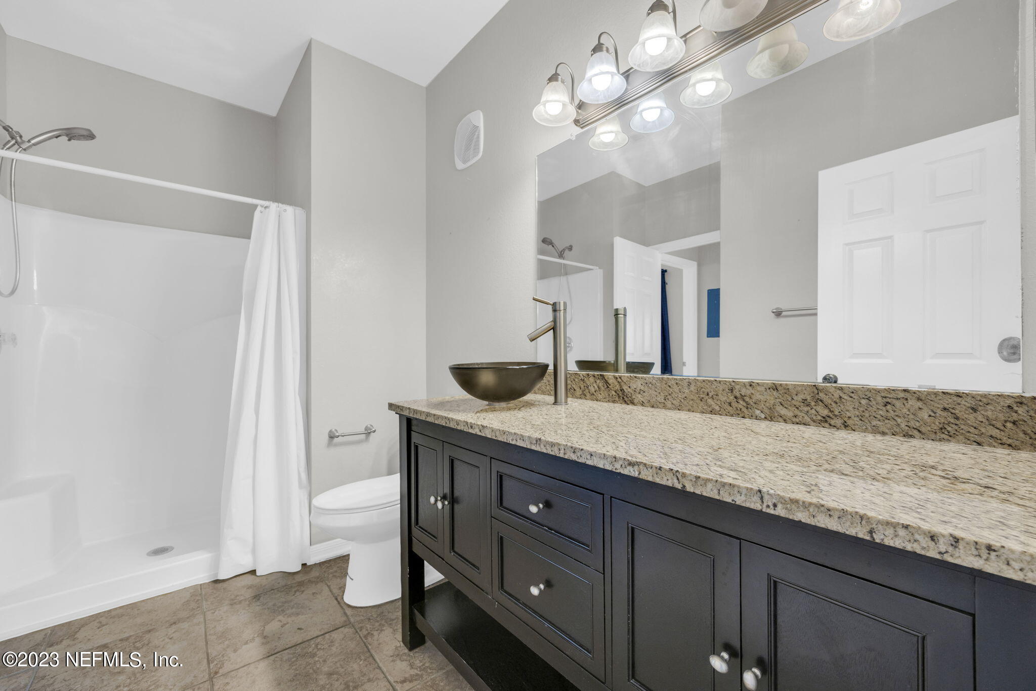 10961 Burnt Mill Road, Unit 427 Jacksonville, FL 32256 - Photo 23 of 50 a bathroom with a granite countertop double vanity sink and a mirror