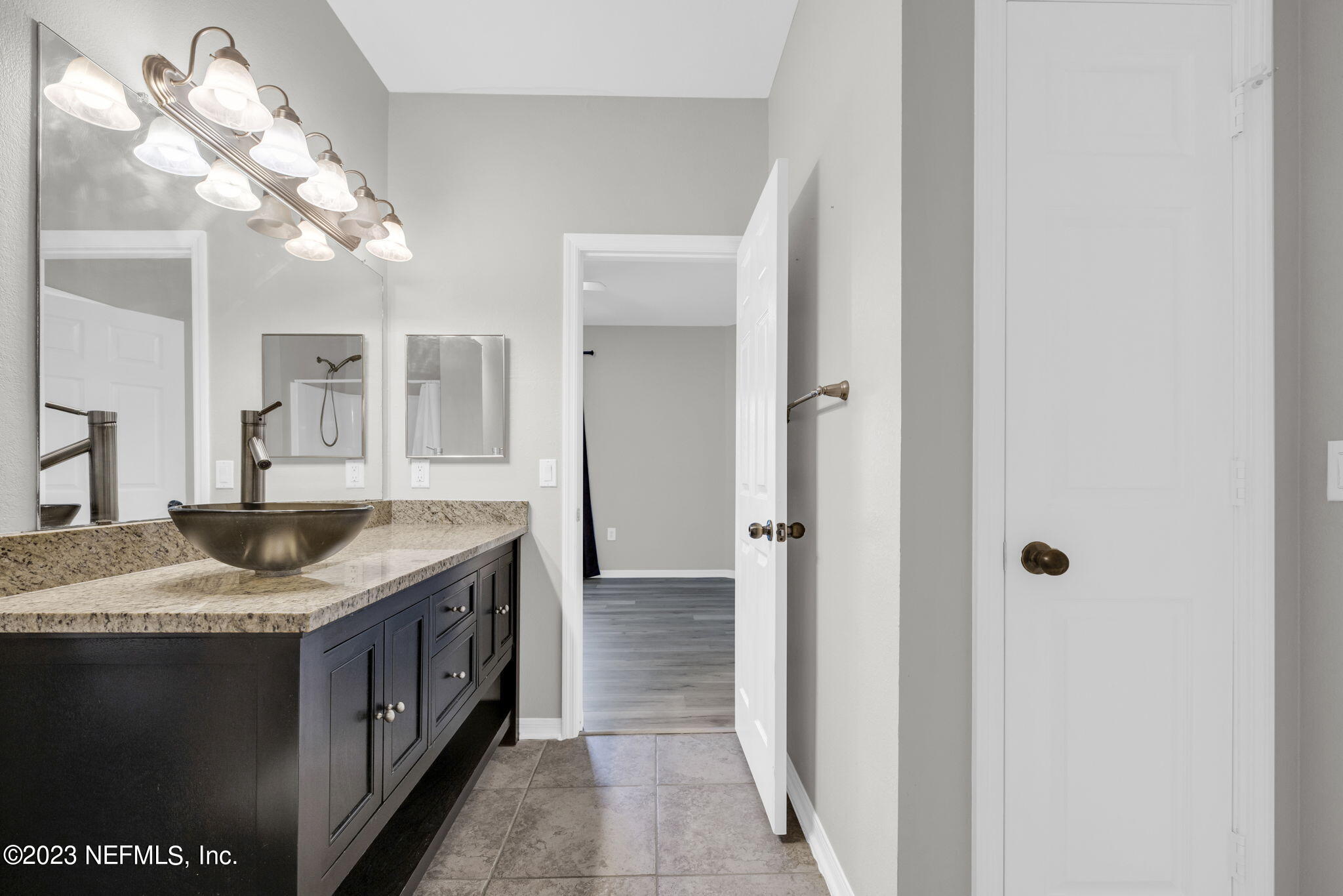 10961 Burnt Mill Road, Unit 427 Jacksonville, FL 32256 - Photo 24 of 50 a bathroom with a granite countertop sink a mirror and shower