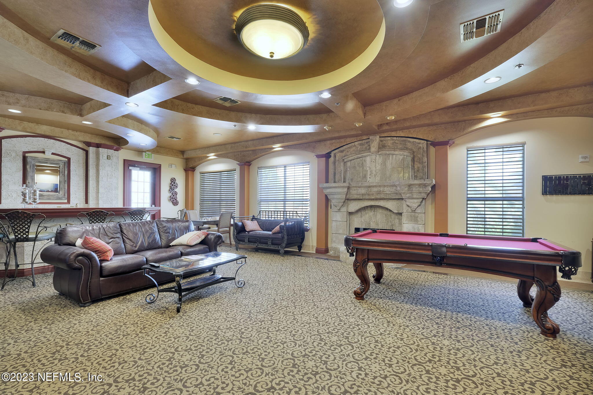 10961 Burnt Mill Road, Unit 427 Jacksonville, FL 32256 - Photo 32 of 50 a living room with furniture gym equipment and a large window