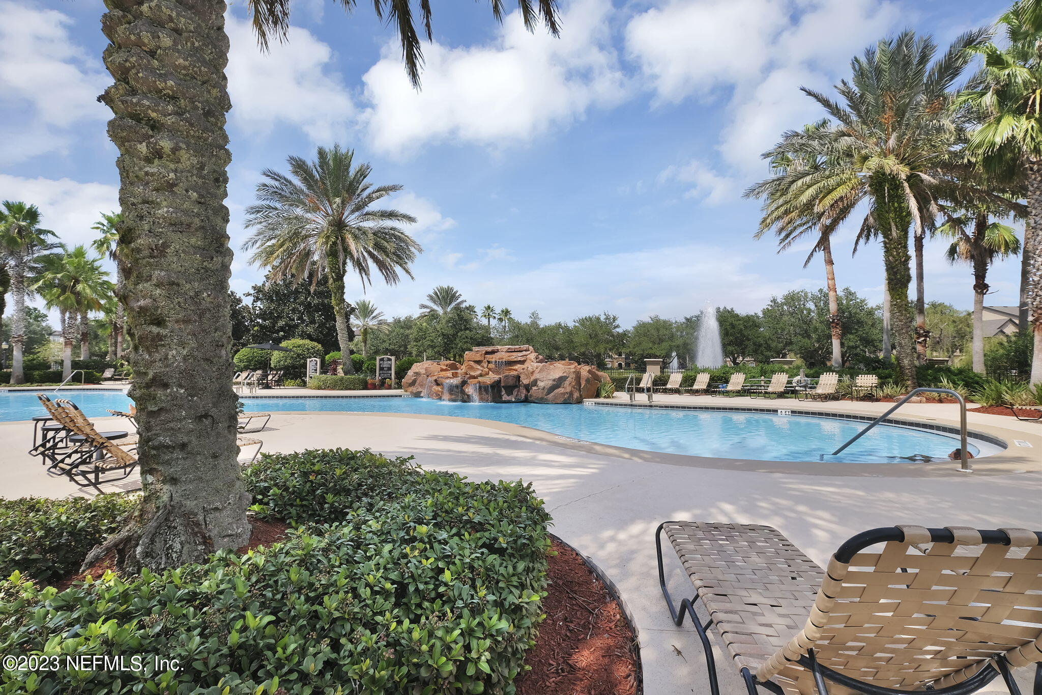 10961 Burnt Mill Road, Unit 427 Jacksonville, FL 32256 - Photo 38 of 50 a view of a swimming pool with a table and chairs