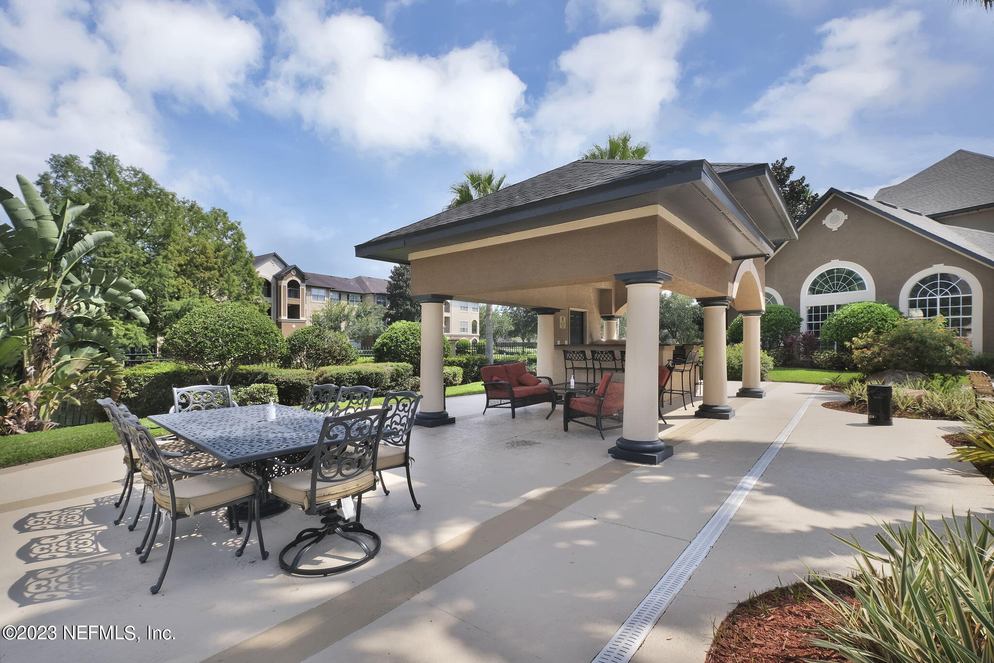 10961 Burnt Mill Road, Unit 427 Jacksonville, FL 32256 - Photo 41 of 50 a view of a patio with table and chairs under an umbrella