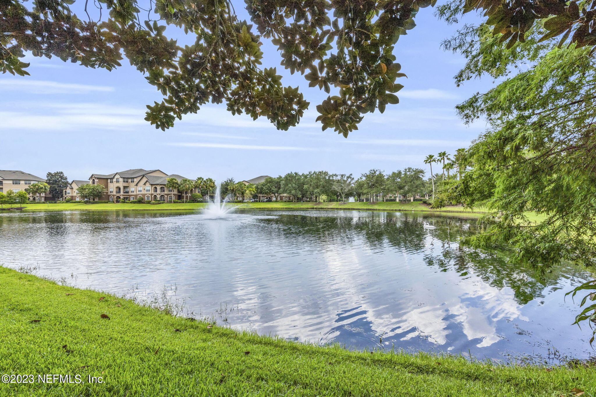 10961 Burnt Mill Road, Unit 427 Jacksonville, FL 32256 - Photo 45 of 50 a view of a lake with a house in the background