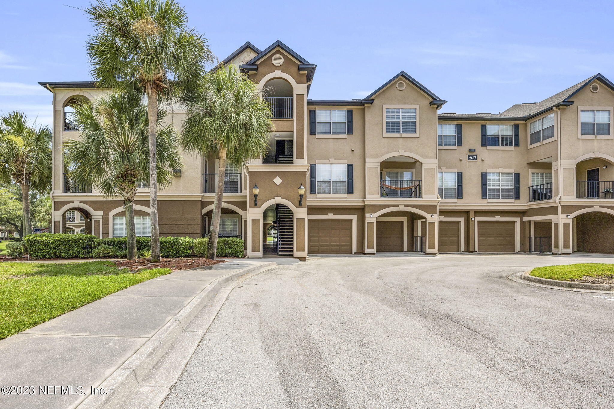 10961 Burnt Mill Road, Unit 427 Jacksonville, FL 32256 - Photo 46 of 50 a front view of a house with a garden and plants