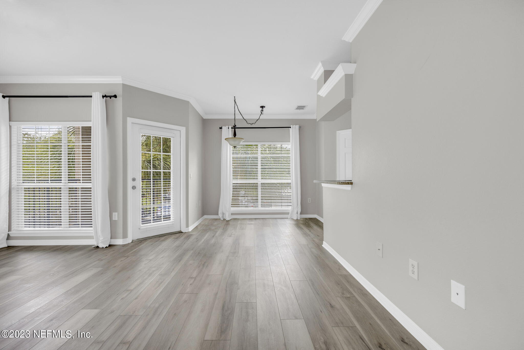 10961 Burnt Mill Road, Unit 427 Jacksonville, FL 32256 - Photo 8 of 50 wooden floor in an empty room with a window
