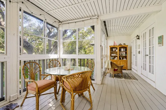 a dining room with furniture a chandelier and wooden floor